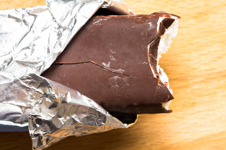 Bitten ice cream with chocolate on a stick top viewの写真素材