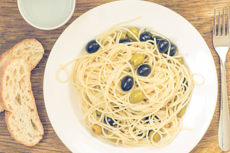Spaghetti alle olive on the table top viewの写真素材