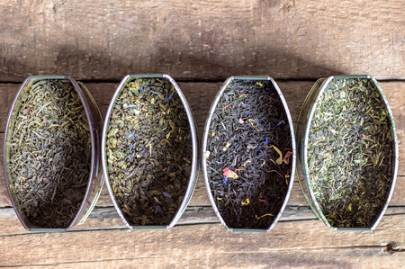 Collection assortment of dry tea in tin cans. Rustic style for backgroundの写真素材