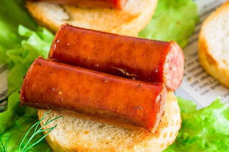 Tapas appetizer with smoked sausage on toastの写真素材