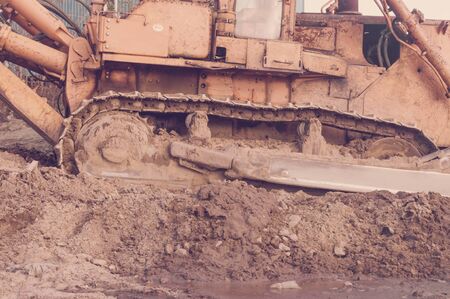 Old bulldozer track in mud and sandの写真素材