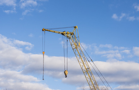 Mobile crane boom against the blue sky