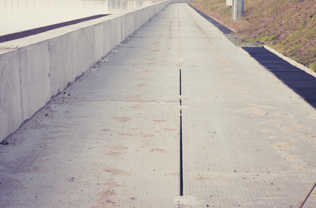 Embankment concrete slabs dam on the riverの写真素材