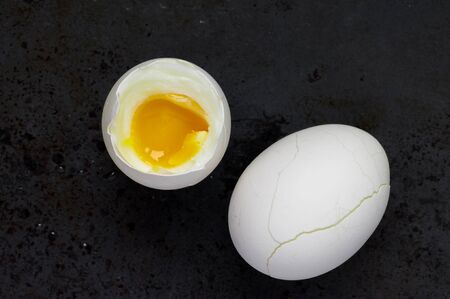 Boiled egg on a black background top viewの写真素材