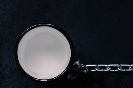 Mug with remnants of water with steel chain top viewの写真素材