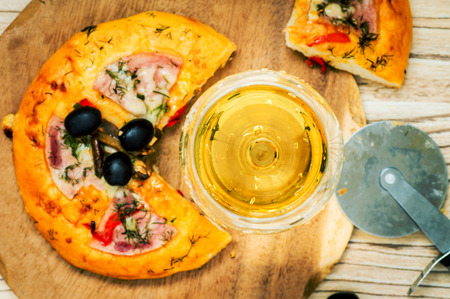 White wine wineglass and pizza on table top viewの写真素材