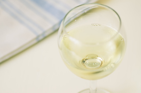 Glass of cool white wine on the tableの写真素材