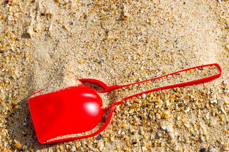 On the sand of the sea kids scoop top view close-upの写真素材