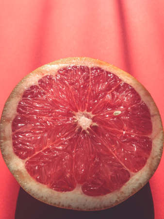 Slice, half grapefruit on red top viewの写真素材