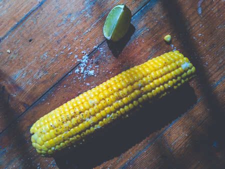 Sweet corn on the table with limes Top view