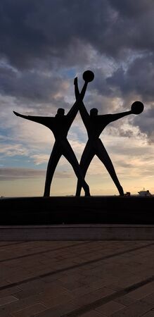 Monument to the sailor silhouette against sunset sky, Taranto, Italyの写真素材
