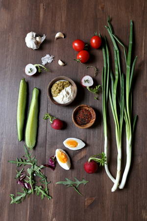 Ingredients for salad: green onions, eggs, radishes, tomatoes and sauce