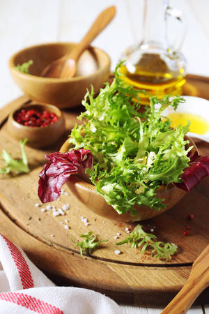 Healthy salad ingredients: mesclin, walnuts and olive oilの写真素材