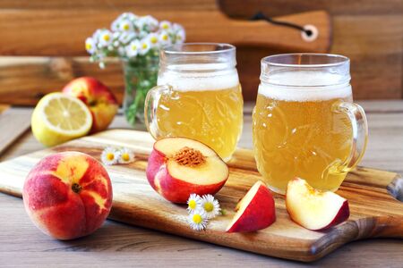 Light fruit craft beer, fruits and bouquet of wildflowersの写真素材