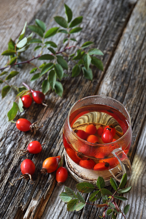 Rosehip tea in glass cup and berriesの写真素材