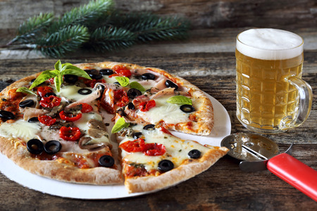 New Year spirit. Appetizer: pizza and mug of lager beerの写真素材