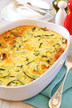 Vegetable marrow squash gratin with cheese and shallot in ceramic bakewareの写真素材