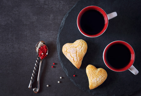 Valentine's Day: two cups of coffee and heart cookies. top view