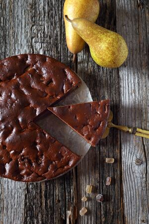 Chocolate pear cake and two pears. Top viewの写真素材