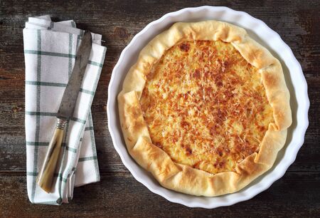 Onion cheese pie on wooden table. Top viewの写真素材