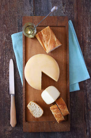 French cheese, baguette and honey on  wooden table. Top view