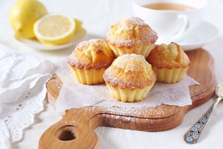 Lemon muffins and cup of tea for breakfastの写真素材