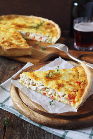 Chicken and bell pepper quiche and two mugs of beerの写真素材