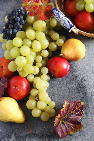Background: autumn fruits in wicker basket. Top viewの写真素材