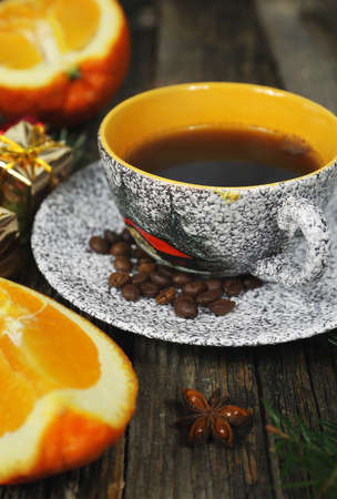 Cup of coffee, coffee beans, orange and Christmas-tree decorations. Toned imageの写真素材
