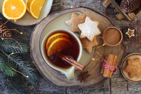 Christmas cinnamon cookies (spice-cake),  cup of spicy tea and New Year's decoration. Rustic style. Top viewの写真素材