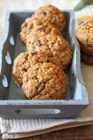 Homemade oatmeal cookies with raisins and walnuts in basketの写真素材