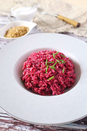 Pink rice. Beetroot risotto from brown rice with almond milk, chives onion dressing. Diet food.の写真素材
