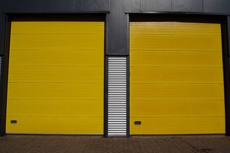 Warehouse with yellow roller doorsの写真素材