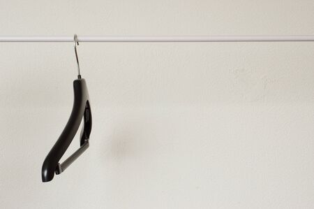 One empty cloth hanger on rackの写真素材