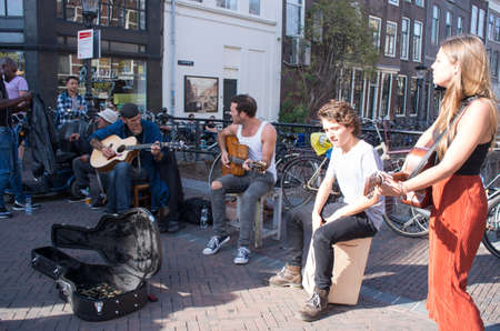 Utrecht, Netherlands - October 10, 2018: Four street musicians give performance on guitar