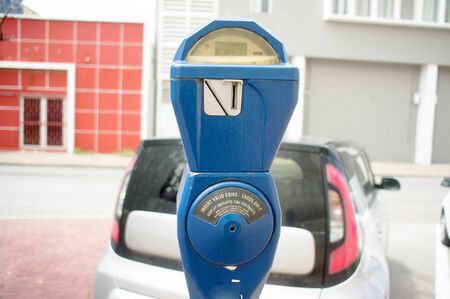 Blue vintage parking meter with a car in the background in Willemstad, Curacaoの写真素材