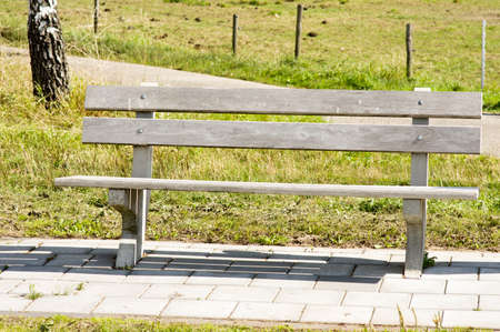 Brown wooden bench outdoors in Arnhem, Netherlands