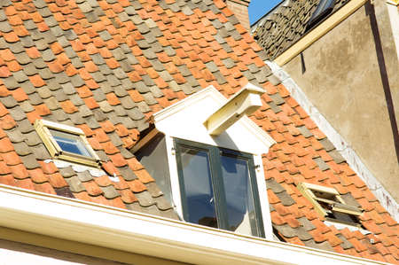 Closeup of red and black tiles on a roof of an monumental house in Zutphen, Netherlands