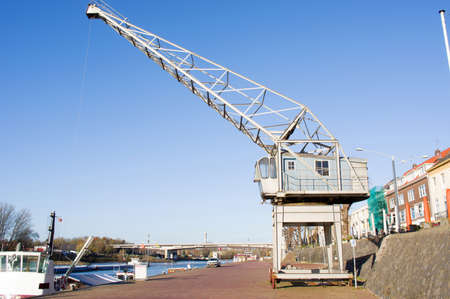 Large industrial crane in the harbor on a quay of the river Rhine in Arnhem, Netherlandsの写真素材