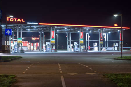 Arnhem, Netherlands - November 27, 2020: Total petrol station illuminated at night. Total SE is a French multinational integrated oil and gas companyのeditorial素材