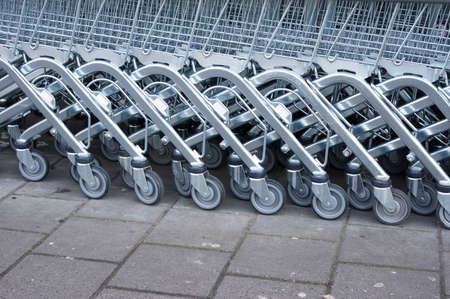 Rows of silver shopping carts at a supermarket