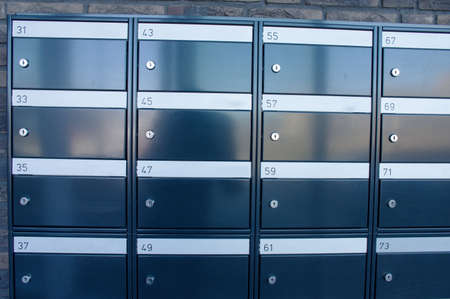 Wall with brown mailboxes inside an apartmentの写真素材
