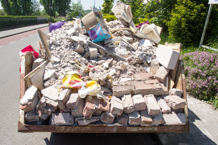 Arnhem, Netherlands - May 30,2021: Closeup of a dumpster with construction wasteのeditorial素材