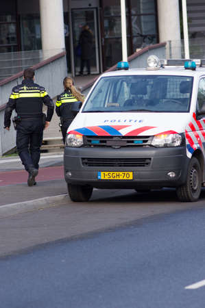 Nijmegen, Netherlands - January 14, 2020: Dutch police officers walking away from a police carのeditorial素材