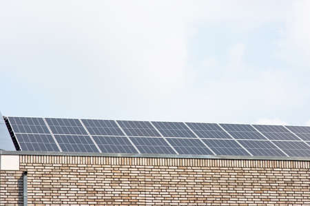 Modern solar panel on a brown roof for electric power generationの写真素材
