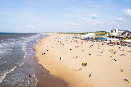 Den Haag, Netherlands - August 24,2021: People swimming and relaxing on the beach at Scheveningen at a sunny dayのeditorial素材
