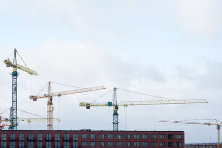 Building under construction with large cranes on top in Nijmegen in the Netherlandsの写真素材