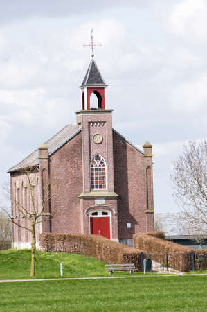 The front of a facade of a small church in dutch village, Homoet in the Netherlandsのeditorial素材