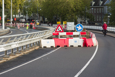 Arnhem, Netherland - November 4, 2022: Work site closed with roadblocks for road works with road workersのeditorial素材