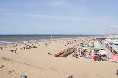 Scheveningen, Netherlands - August 24, 2021: People enjoying at a busy beach or at a terrace of a beach tent on a sunny dayのeditorial素材